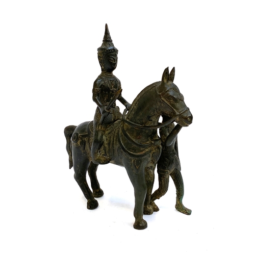 422 - A Burmese bronze figure of a deity on a horse, 28cmH