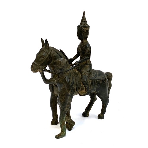 422 - A Burmese bronze figure of a deity on a horse, 28cmH