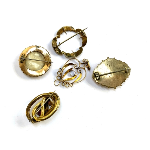 34 - A lot of various Victorian gilt metal brooches; together with an Art Nouveau heart shaped pendant (a... 