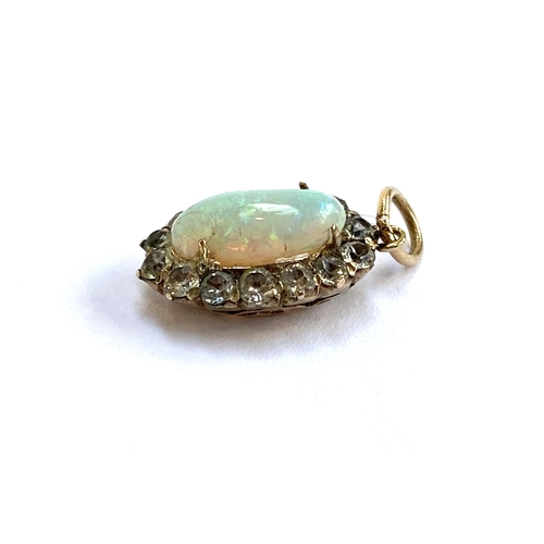 39 - An early 20th century yellow metal mounted opal and white sapphire pendant (af), 1.4cmL excluding ba... 