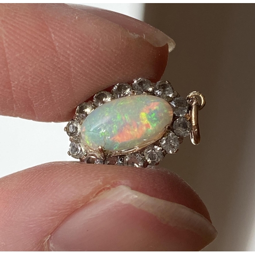 39 - An early 20th century yellow metal mounted opal and white sapphire pendant (af), 1.4cmL excluding ba... 