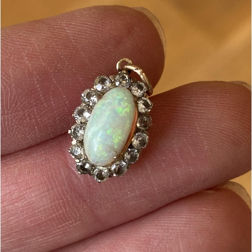 39 - An early 20th century yellow metal mounted opal and white sapphire pendant (af), 1.4cmL excluding ba... 