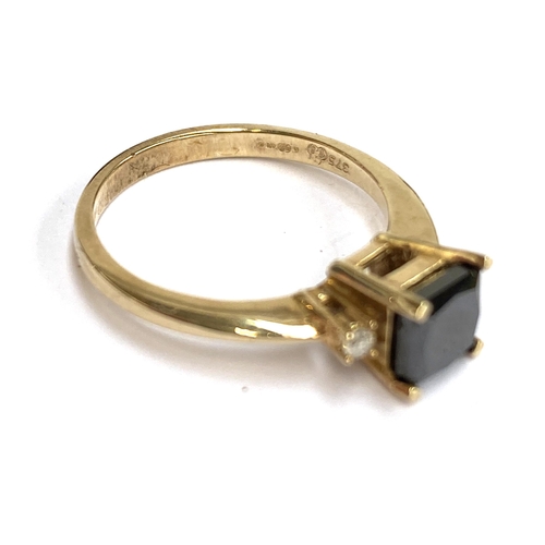 46 - A 9ct gold ring set with a princess cut black diamond measuring 4.5x4.5x3.8mm, approx. 0.6ct, flanke... 