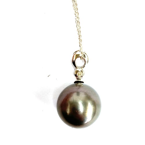 48 - A 18ct white gold mounted black Tahitian pearl pendant, the bail set with a small diamond, the pearl... 