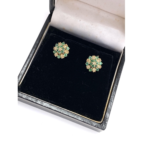 50 - A pair of 9ct gold, emerald and diamond floral cluster stud earrings, 1.4cm diameter, gross weight 2... 