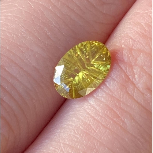 52 - A loose sphene, oval mixed cut 1.75cts, 9.37x6.47x3.62