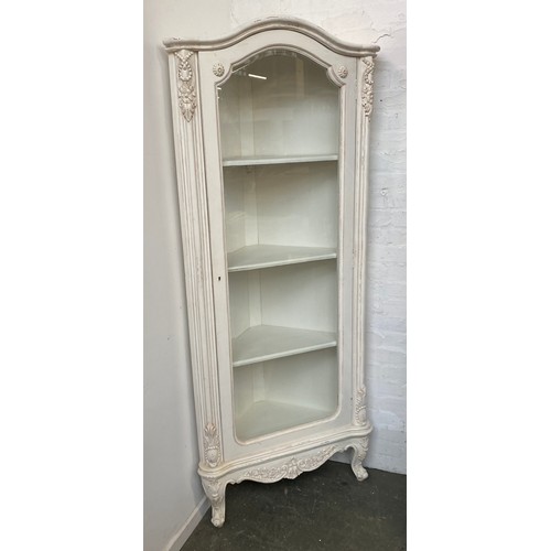 1059 - A white painted glazed corner cupboard with bevelled glass, 193cmH