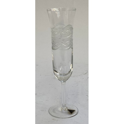 428 - Four boxes of engraved lead crystal glass champagne flutes (24) 20cmH together with four more boxes ... 