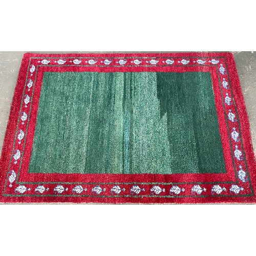 1071 - A green ground rug with bright red border, 124x88cm