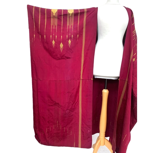 763 - A c.1900 burgundy and gold cotton Abaya with geometric gold braid and woven design, 51