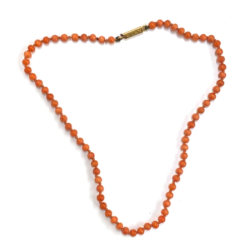 69 - A Victorian coral bead necklace, fastening with a gold clasp engraved 'G.E.D C.M.D.R', the beads app... 