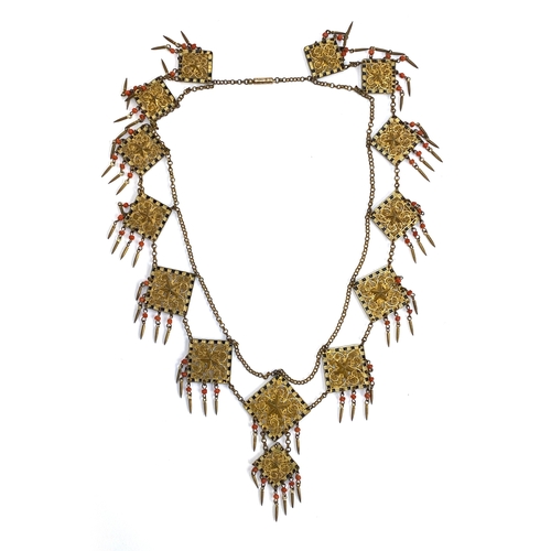 82 - An early 20th century Czech gilt metal filigree necklace, the square panels with applied star detail... 
