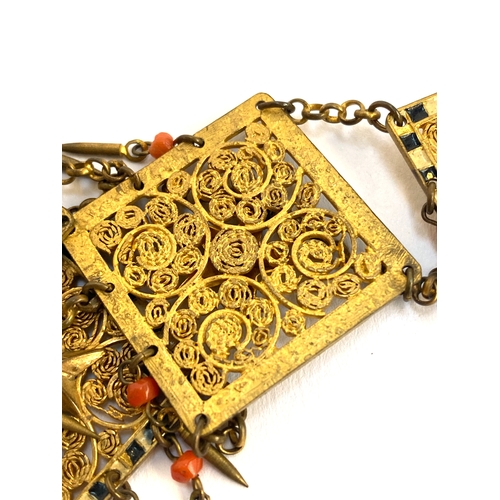 82 - An early 20th century Czech gilt metal filigree necklace, the square panels with applied star detail... 