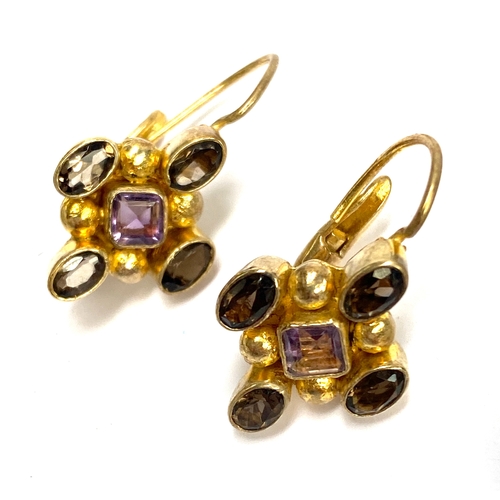 100 - A 925 silver CZ and red drop pendant on chain; amethyst and smoky quartz 925 silver gilt earrings; a... 