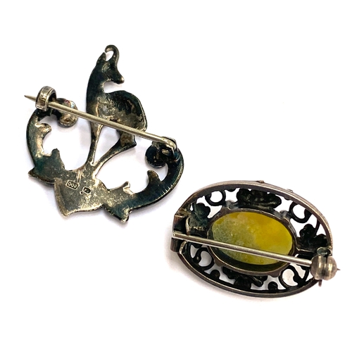 101 - An early 20th century 800 silver antelope brooch; and Bernard Instone style silver and Connemara mar... 
