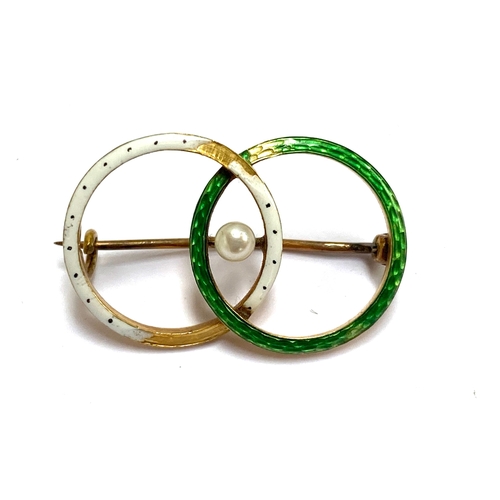 119 - An Edwardian gold and enamel brooch designed as interlocking circles set with a central pearl, ermin... 