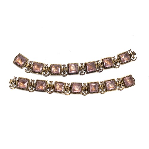 97 - A pair of late 19th/early 20th century gilded white metal bracelets set with amethyst paste, each 17... 
