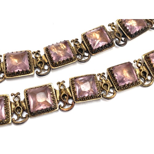 97 - A pair of late 19th/early 20th century gilded white metal bracelets set with amethyst paste, each 17... 
