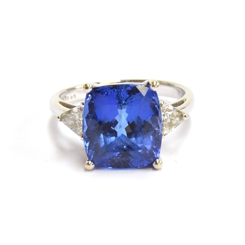 66 - An 18ct white gold, tanzanite and diamond ring, the cushion cut tanzanite 8.45cts and measuring 11.8... 