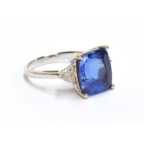 66 - An 18ct white gold, tanzanite and diamond ring, the cushion cut tanzanite 8.45cts and measuring 11.8... 
