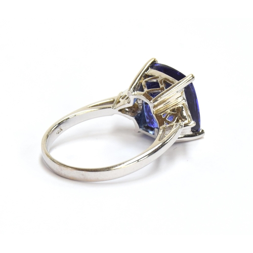 66 - An 18ct white gold, tanzanite and diamond ring, the cushion cut tanzanite 8.45cts and measuring 11.8... 