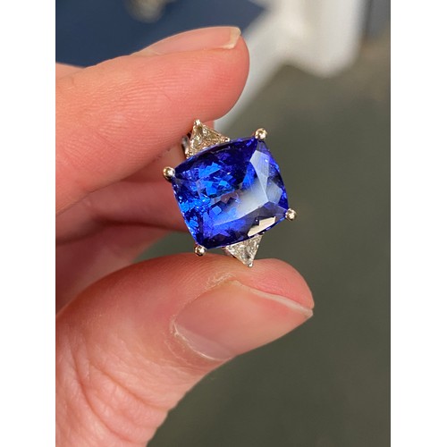 66 - An 18ct white gold, tanzanite and diamond ring, the cushion cut tanzanite 8.45cts and measuring 11.8... 