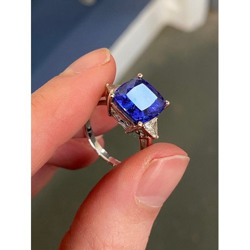 66 - An 18ct white gold, tanzanite and diamond ring, the cushion cut tanzanite 8.45cts and measuring 11.8... 