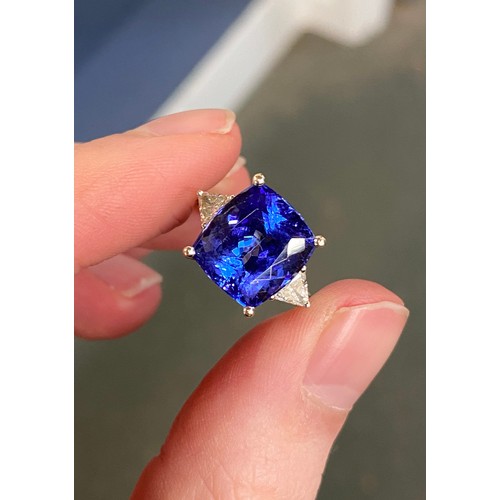 66 - An 18ct white gold, tanzanite and diamond ring, the cushion cut tanzanite 8.45cts and measuring 11.8... 