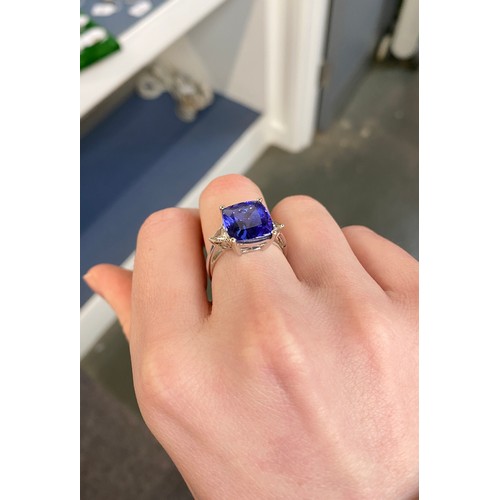 66 - An 18ct white gold, tanzanite and diamond ring, the cushion cut tanzanite 8.45cts and measuring 11.8... 