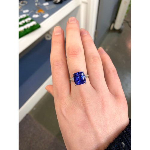 66 - An 18ct white gold, tanzanite and diamond ring, the cushion cut tanzanite 8.45cts and measuring 11.8... 