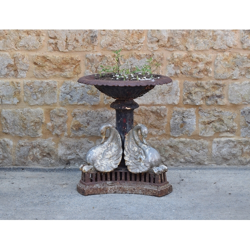 574 - A Victorian cast iron tazza urn, the egg and dart flared top on a fluted column, the trefoil base su...