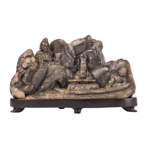652 - A Chinese carved hardstone boulder group of Lu Dongbin surrounded by attendants, a pagoda in a mount... 