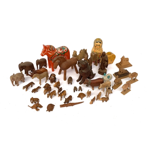 667 - A good variety of carved wooden figures, mostly animals, to include a Matryoshka