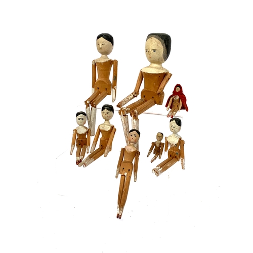 693 - A collection of 19th century Dutch Grodnertel type wooden peg dolls (af), the largest 30cmH
