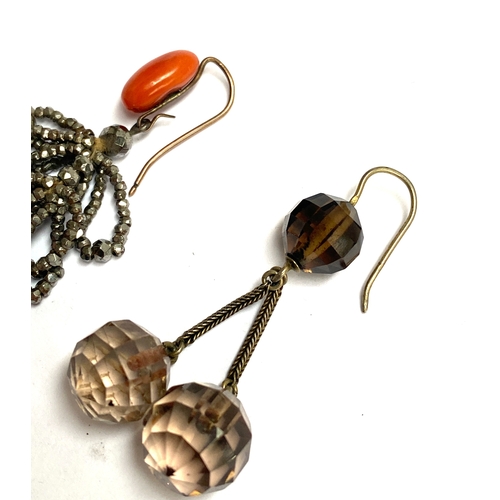 27 - Two single earrings: a 19th century cut steel and coral hook earring; and a smoky quartz and silver ... 