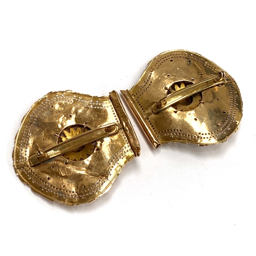 1 - A buckle converted into two brooches, testing as 14ct with later 9ct brooch fittings, each section a... 