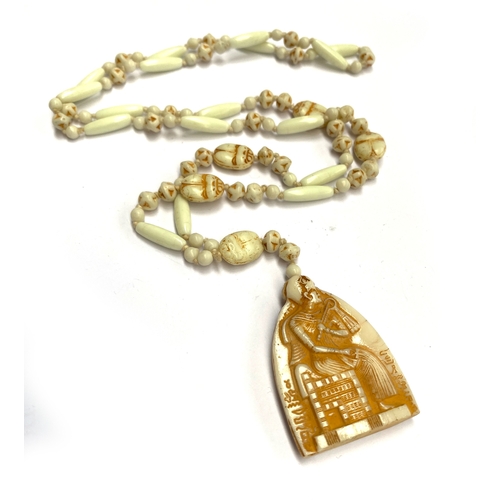 42 - A Czech Neiger style Art Deco Egyptian revival necklace with scarab beads and pharaoh pendant, 49cmL