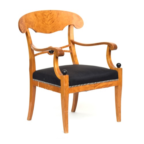 A Biedermeier style satin birch open armchair with close nailed seat