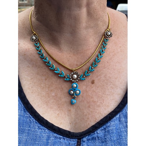 41 - A Victorian gold necklace, the snake chain suspending swags of channel set turquoise leaves interspe... 