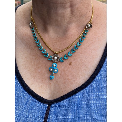 41 - A Victorian gold necklace, the snake chain suspending swags of channel set turquoise leaves interspe... 