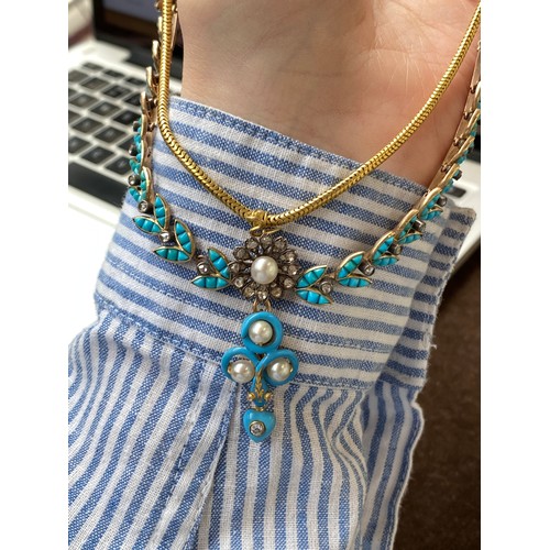 41 - A Victorian gold necklace, the snake chain suspending swags of channel set turquoise leaves interspe... 
