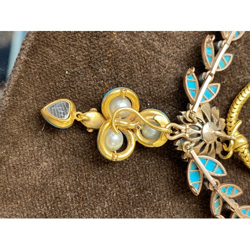 41 - A Victorian gold necklace, the snake chain suspending swags of channel set turquoise leaves interspe... 