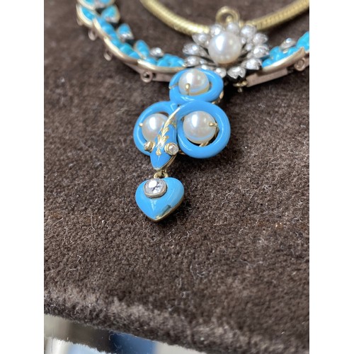 41 - A Victorian gold necklace, the snake chain suspending swags of channel set turquoise leaves interspe... 