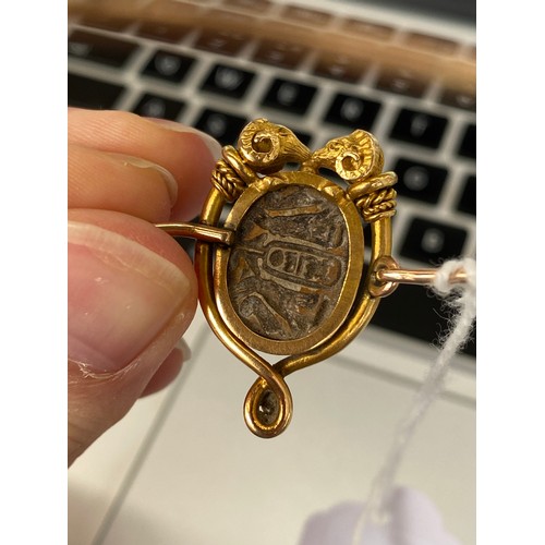 42 - A Victorian archaeological revival bangle, faience scarab mounted in high carat gold in the form of ... 