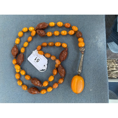 51 - An early 20th century amber bead necklace, the knotted beads each approx. 13mm long, interspersed wi... 