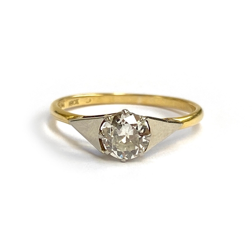 An Art Deco 18ct gold and platinum solitaire ring with geometric platinum shoulders, set with a large diamond measuring approx. 6mmD and weighing approx. 0.7ct, size Q, 2.1g