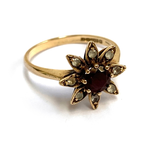 42 - A vintage 9ct gold floral cluster ring set with a central garnet and white stones, size P, 2.7g