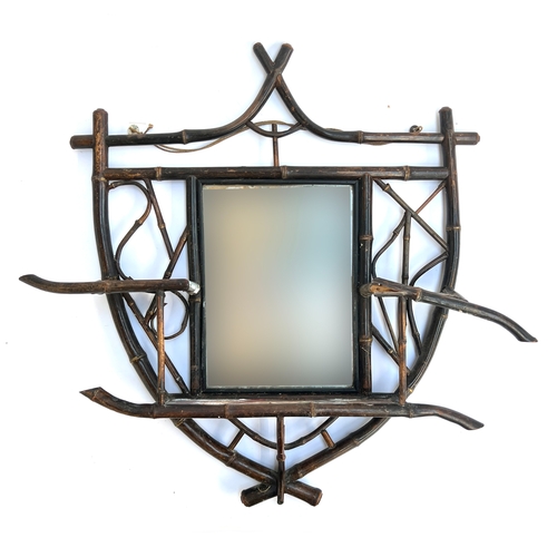 Interior design interest: A shield shaped bamboo hall mirror (af), with central rectangular plate, 67cmH, 66cmW