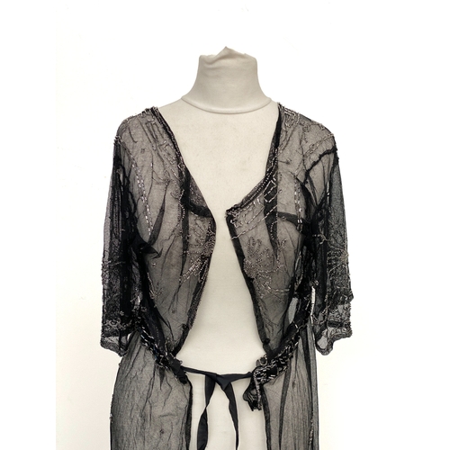 1947 - An early 20th century beaded black lace jacket, with Greek key detail to collar and hem and floral d... 