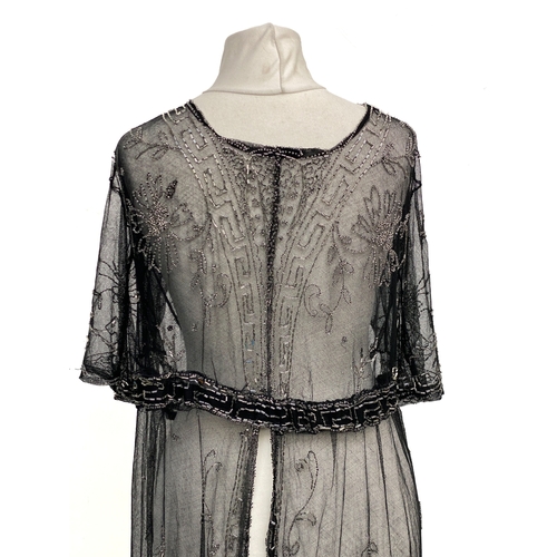 1947 - An early 20th century beaded black lace jacket, with Greek key detail to collar and hem and floral d... 